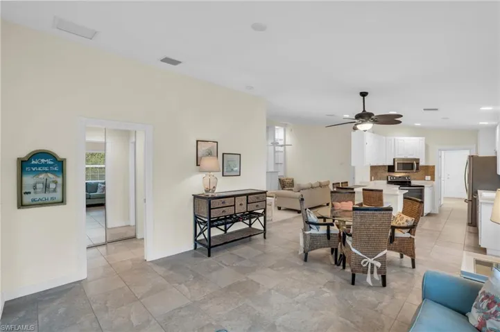 Tiled dining room featuring ceiling fan