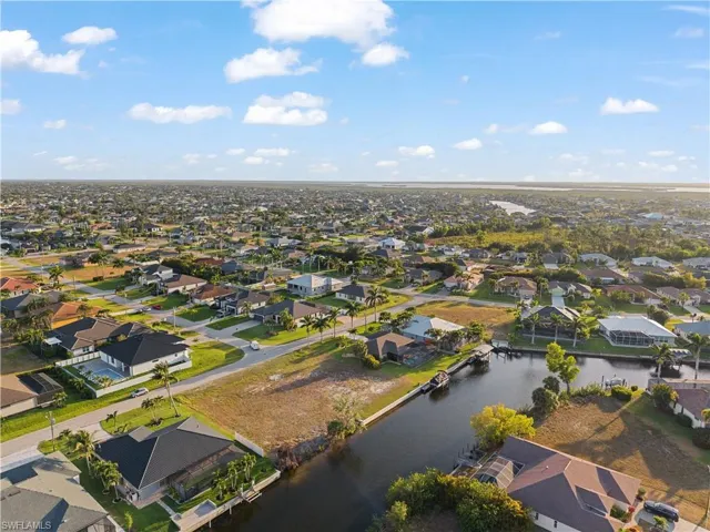 Aerial overview of property's location with nearby suburban area and a nearby body of water