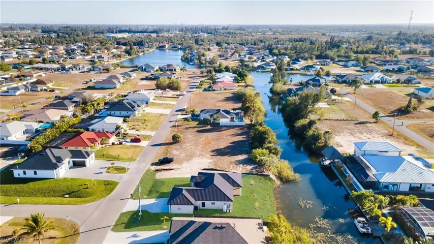 Aerial perspective of suburban area with a nearby body of water