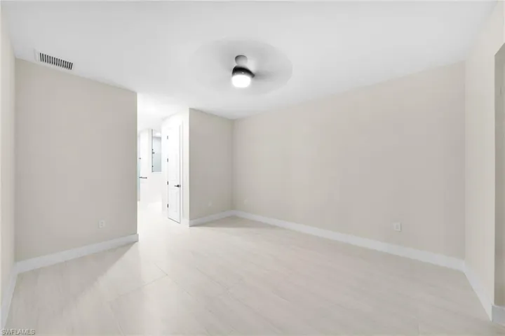 Empty room with baseboards and ceiling fan