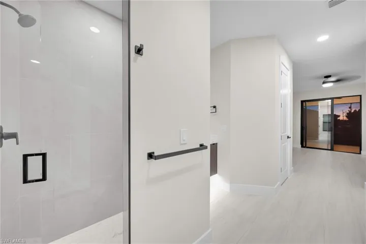 Bathroom with a tile shower and recessed lighting