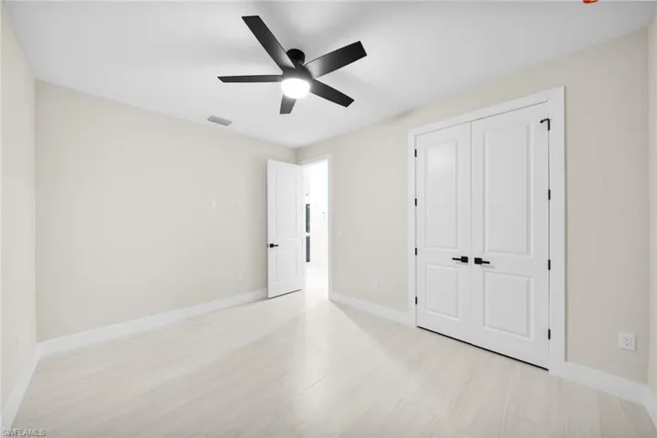 Unfurnished bedroom featuring a ceiling fan and a closet