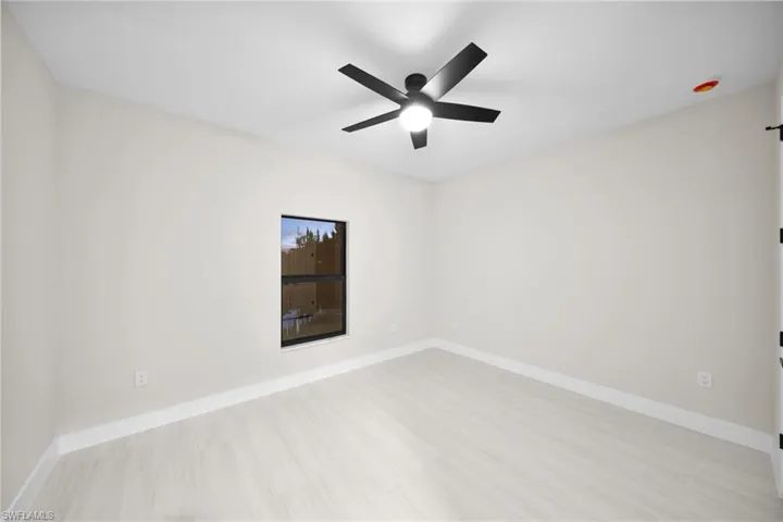 Empty room featuring baseboards and ceiling fan