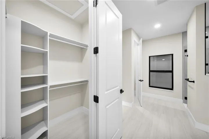 Hall with baseboards and recessed lighting
