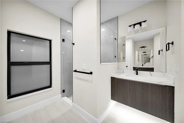 Bathroom with vanity and a stall shower