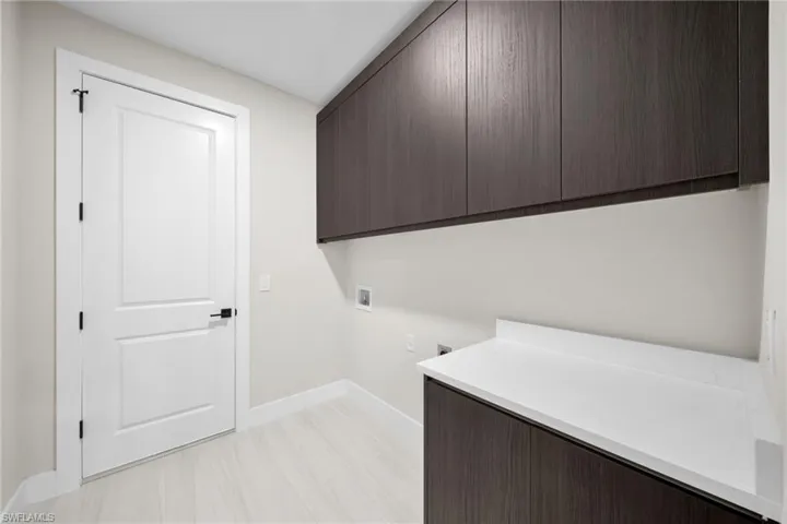 Laundry area featuring hookup for a washing machine, cabinet space, and hookup for an electric dryer