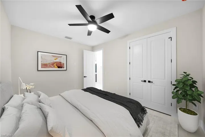 Bedroom with ceiling fan and a closet