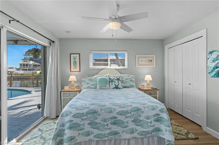 Bedroom with access to outside, a closet, ceiling fan, and light wood-type flooring