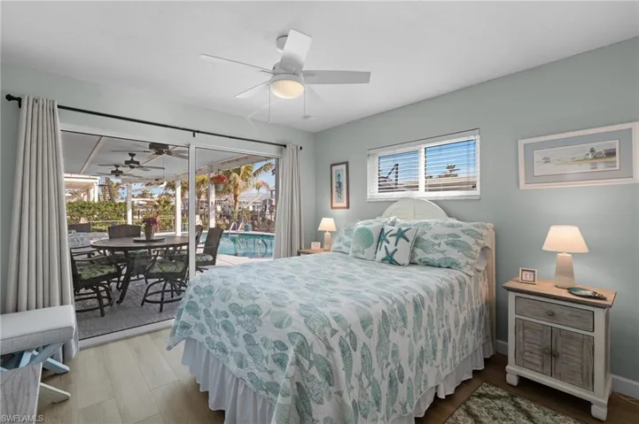 Bedroom featuring ceiling fan, access to exterior, and light wood-type flooring
