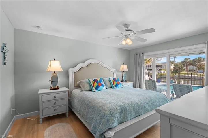 Bedroom with ceiling fan, light hardwood / wood-style flooring, and access to outside