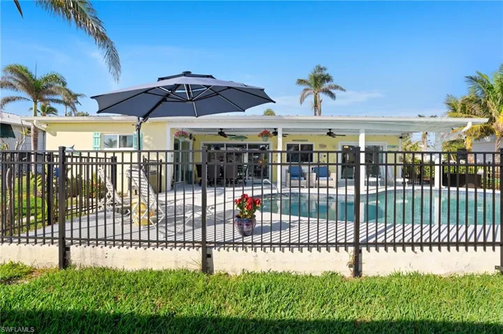 View of swimming pool with a patio area and ceiling fan