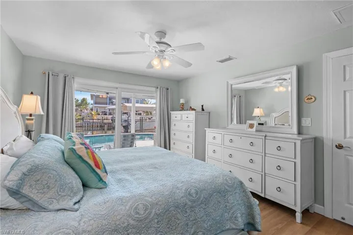 Bedroom with ceiling fan, access to exterior, and light wood-type flooring