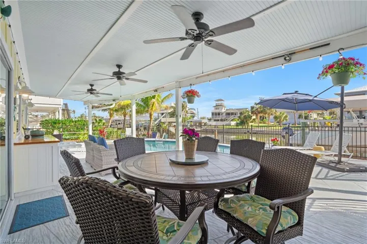 View of patio with a fenced in pool and ceiling fan