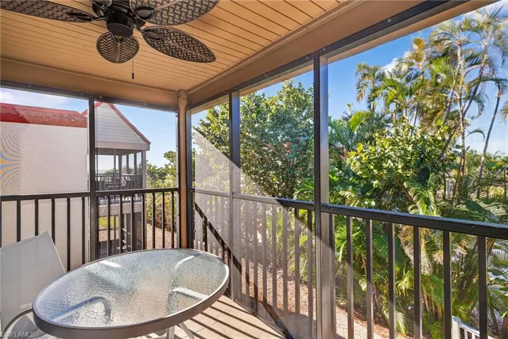 Sunroom / solarium with a balcony, ceiling fan, wooden ceiling, and outdoor dining area