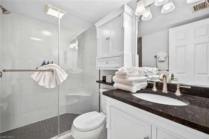 Bathroom featuring vanity and a shower stall