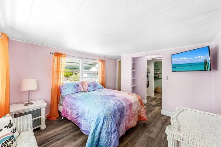 Bedroom with dark wood-type flooring and a textured ceiling