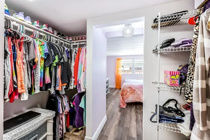 Spacious closet with hardwood / wood-style flooring