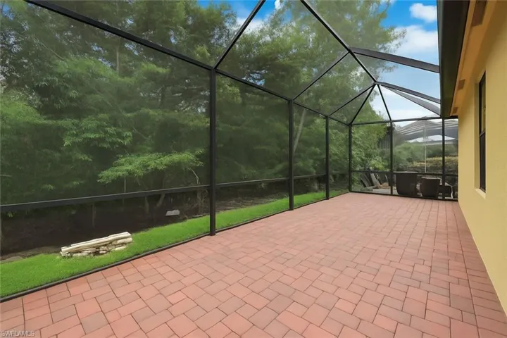 View of patio / terrace featuring a sunroom and a lanai