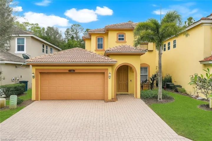 Mediterranean / spanish-style home with stucco siding, decorative driveway, a tile roof, and an attached garage