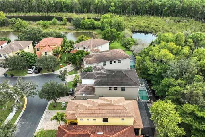 Aerial perspective of suburban area featuring a large body of water