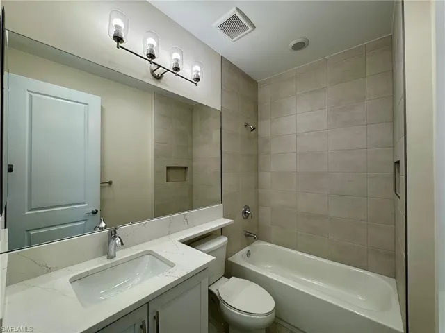 Bathroom with shower / tub combination and vanity
