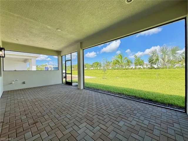 Unfurnished sunroom with a patio area