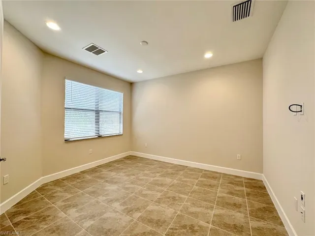 Spare room with recessed lighting and light tile patterned floors