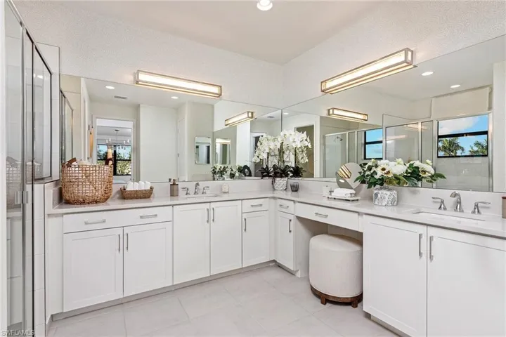 Full bath featuring vanity, a stall shower, tile patterned flooring, and recessed lighting