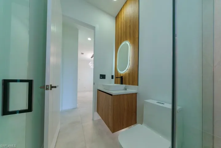 Bathroom featuring vanity, recessed lighting, and tile patterned flooring