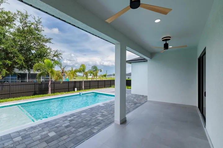 View of pool with a ceiling fan and a patio area