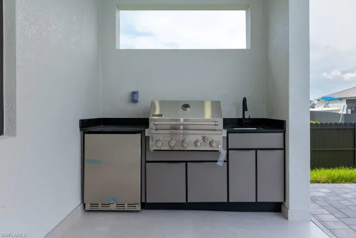 View of patio with a sink and exterior kitchen