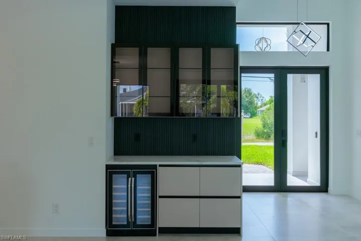 Entryway with beverage cooler and healthy amount of natural light