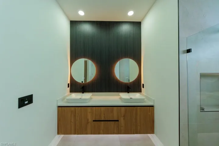 Full bathroom with double vanity and recessed lighting