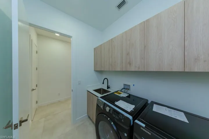 Laundry area with cabinet space and independent washer and dryer
