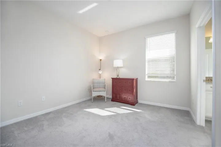 Living area featuring carpet floors and baseboards