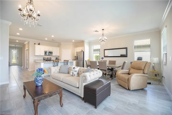 Living area with hanging lights and ornamental molding