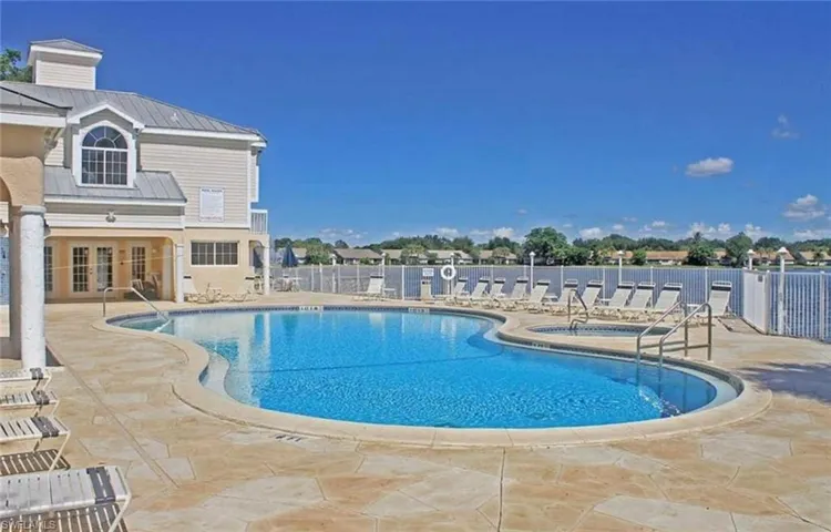Pool with fence, a patio area, and french doors