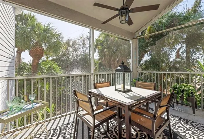 Sunroom / solarium featuring ceiling fan and outdoor dining area