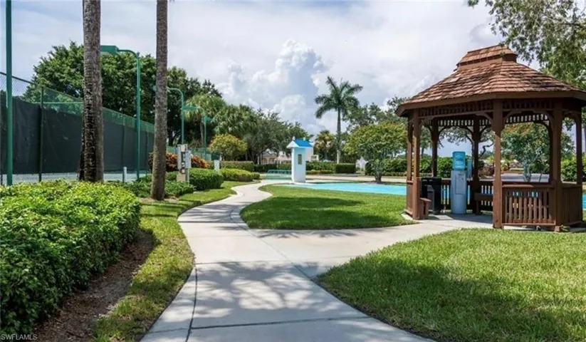 View of property's community featuring a gazebo, a yard, and fence