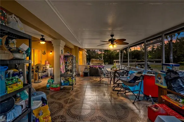 Sunroom / solarium with ceiling fan, outdoor dining area, and a patio area