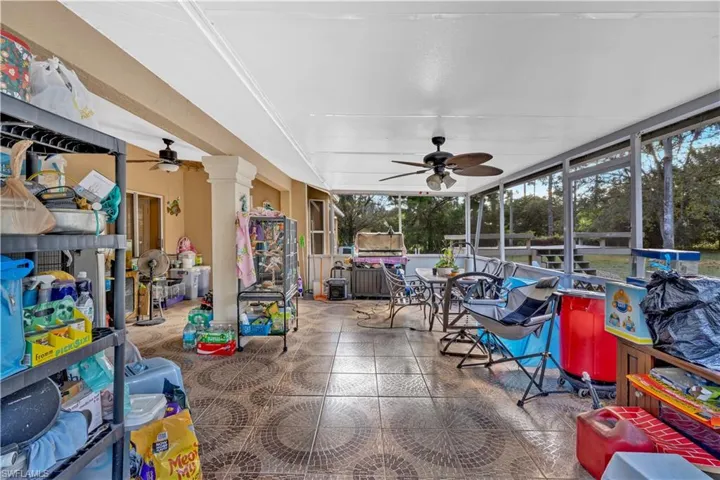 Sunroom / solarium featuring a ceiling fan and outdoor dining area