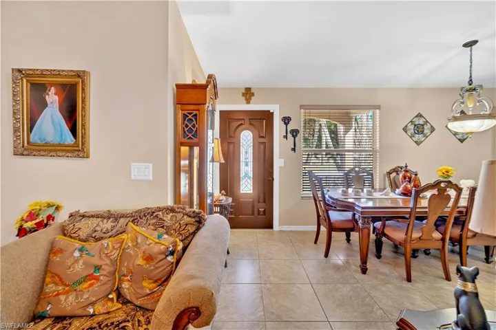 Dining space featuring light tile patterned flooring and baseboards