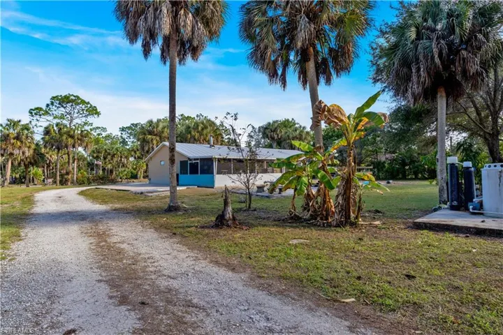 View of front of property with driveway and a front yard