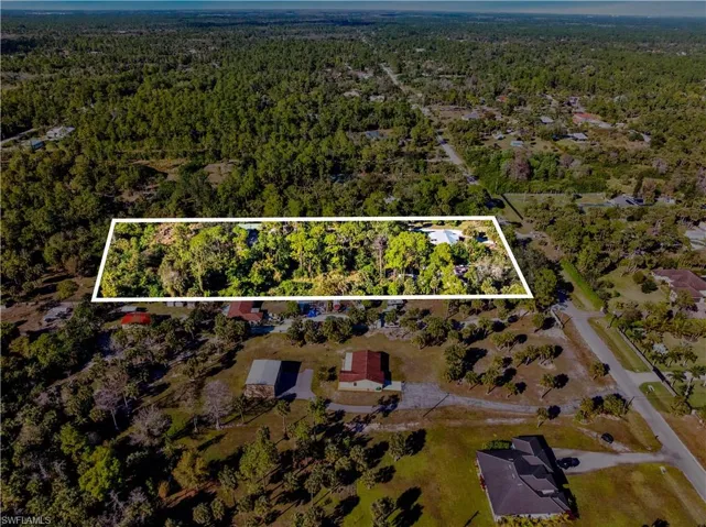 Aerial overview of property's location featuring a forest and property boundaries highlighted
