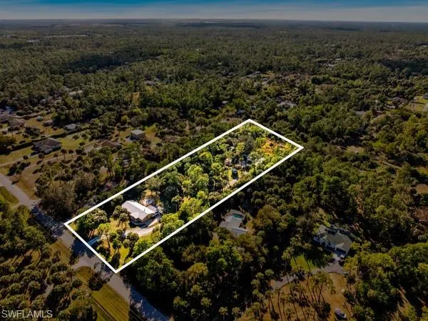 Aerial view of property and surrounding area with a forest and property parcel outlined