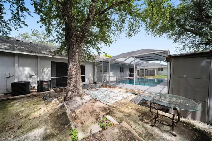 Screened-in swimming pool with a covered enclosure and surrounding patio