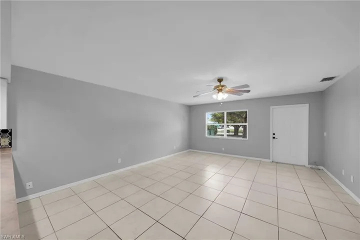 Expansive interior with light gray walls and large-format tile flooring