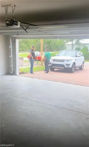 Garage featuring a garage door opener