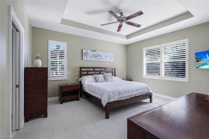 Primary Suite with tray ceiling and direct sliding doors to private outdoor space