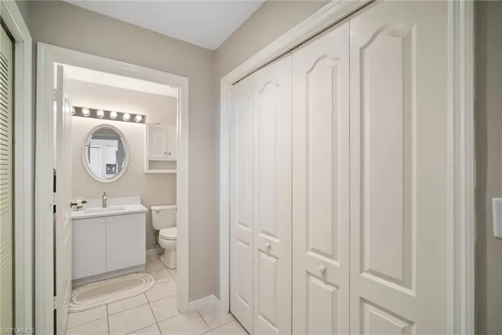 Bathroom with tile patterned floors, vanity, and toilet